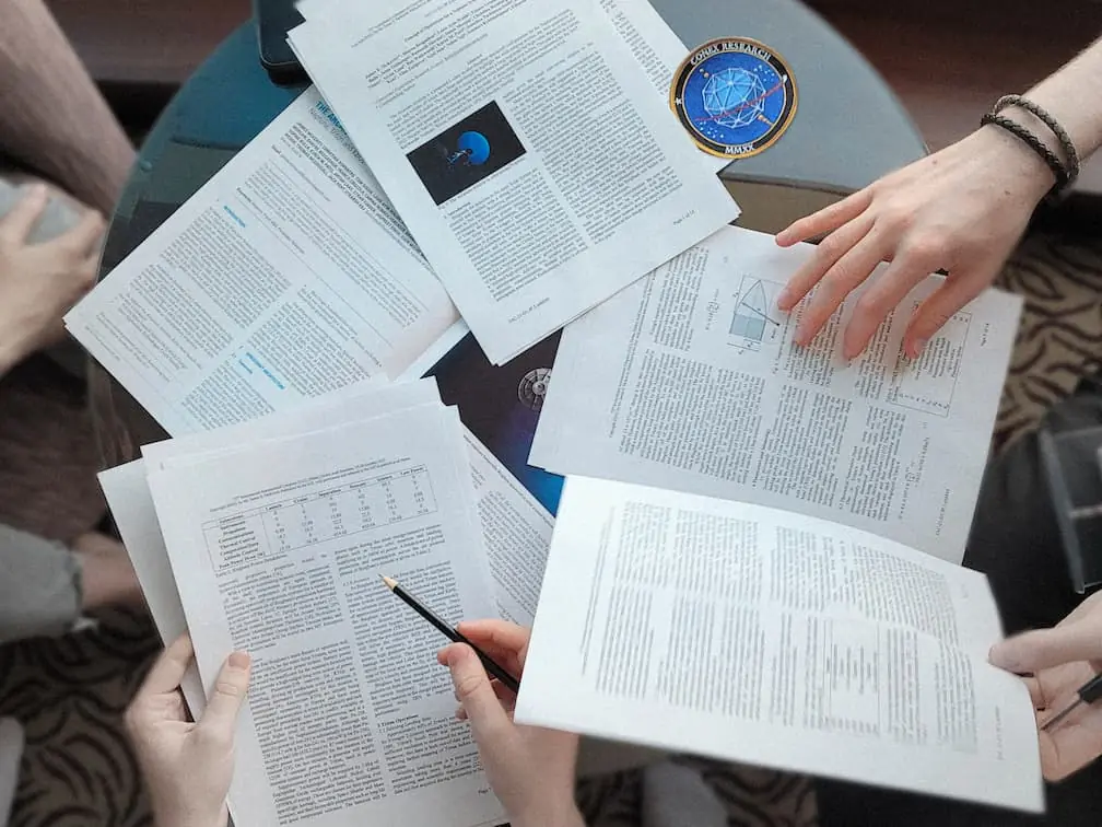 Overhead photo of members working on various papers